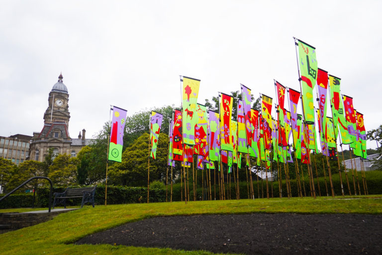 Brightly coloured flags outside Dewsbury Town Hall