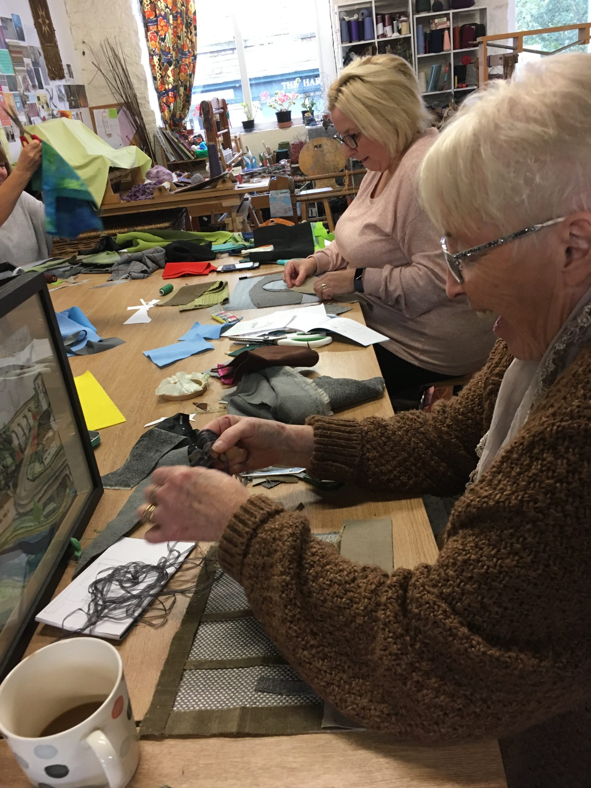 Older ladies taking part in a sewing workshop