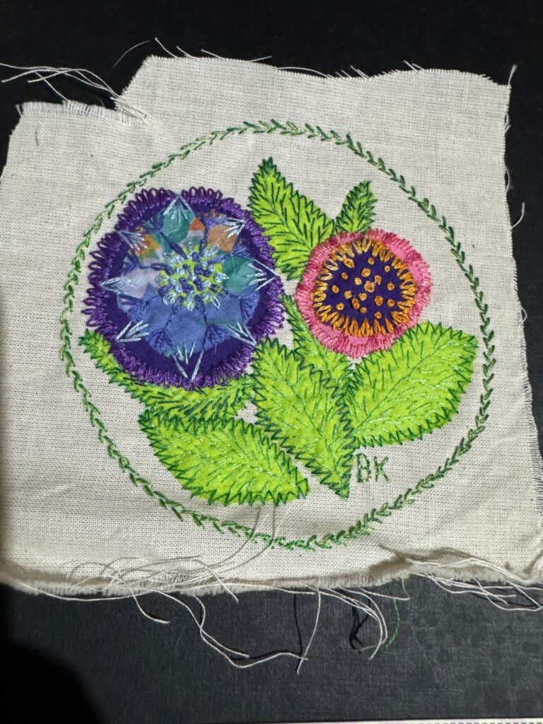A floral handmade embroidered textile patch